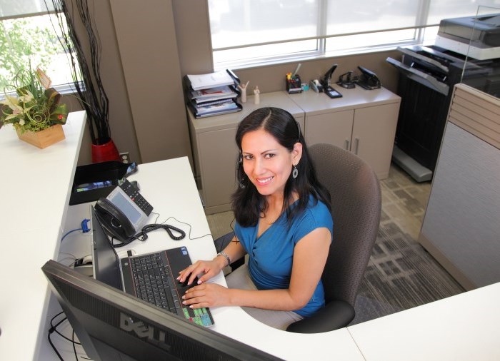 woman sitting at desk smiling