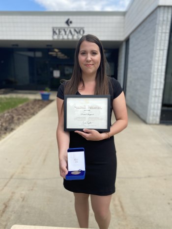 student holding award