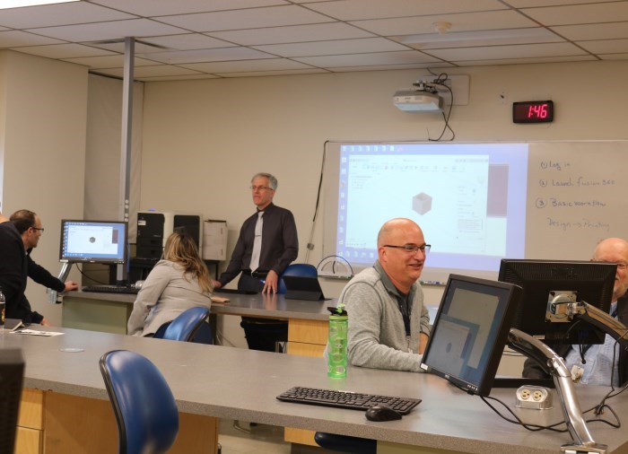 instructors working together in a classroom learning 