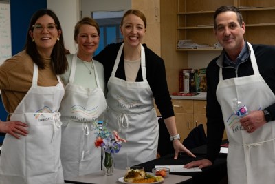 iron chef participants smiling with finished creation displayed