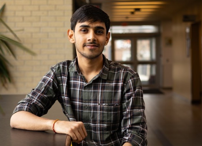 student sitting and smiling