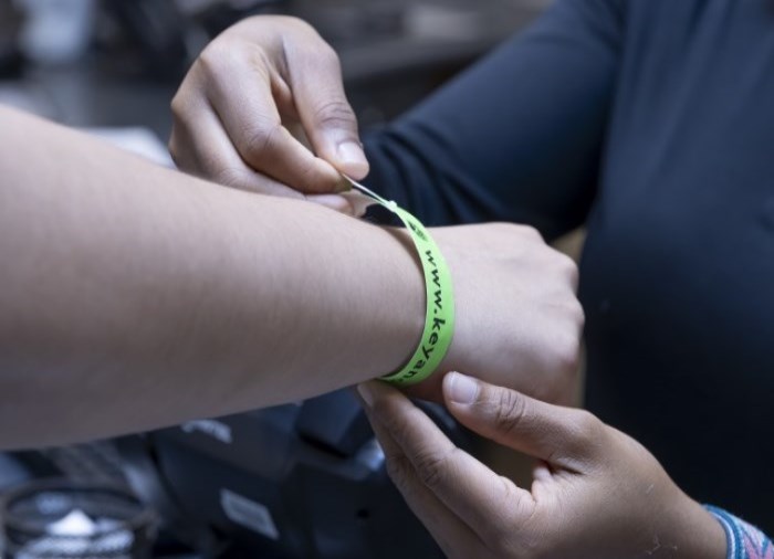 putting wristband on customer