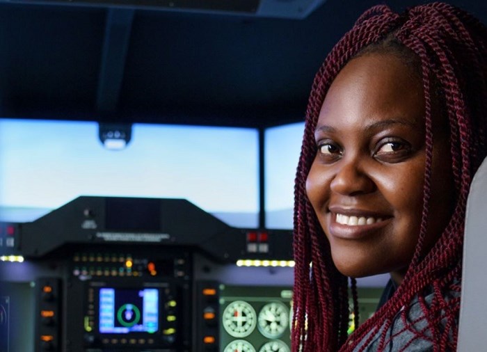 woman smiling in cockpit of plane