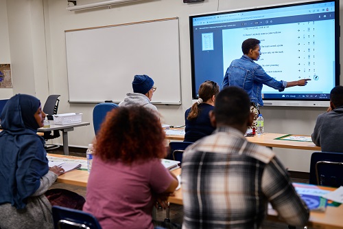 instructor teaching in front of a classroom