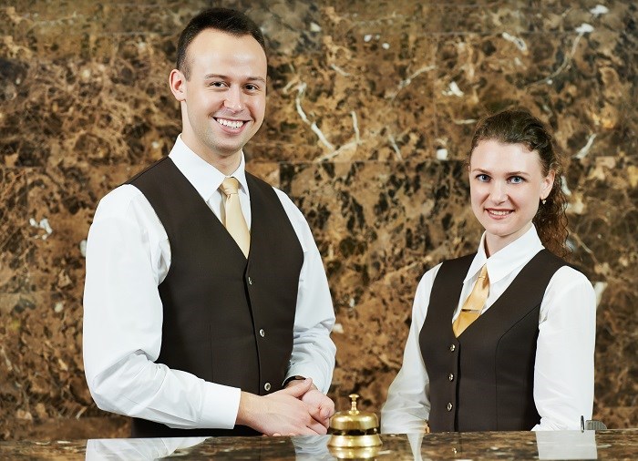 concierge workers standing at hotel counter