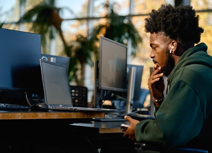 male student working on computer 