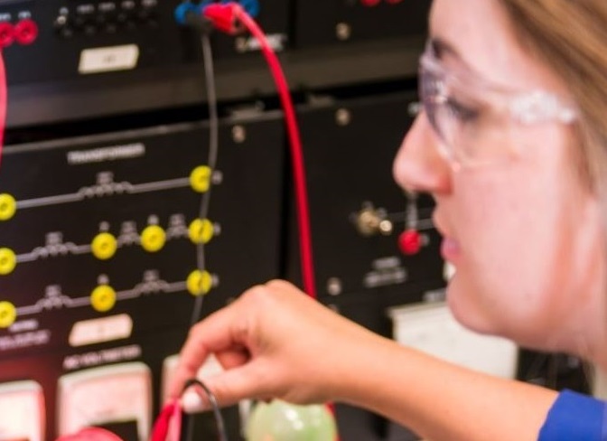 Student working on electrical equipment 