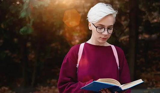 woman reading a book outside