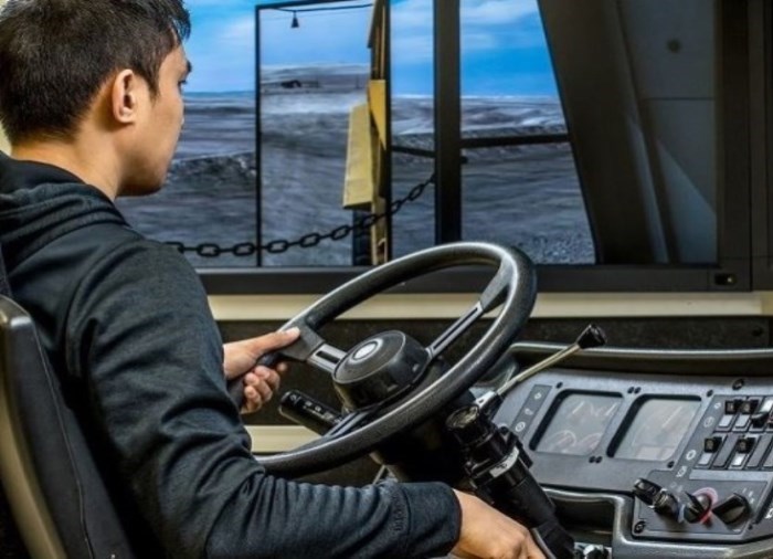 student operating a driver simulator training program