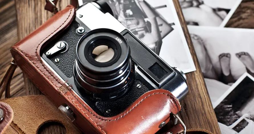 camera sitting on top of photos