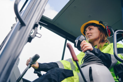 woman operating forklift
