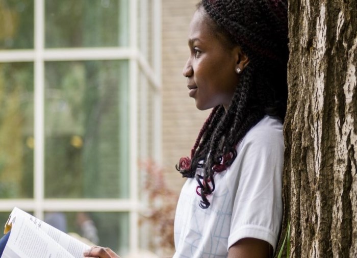 student reading book in park