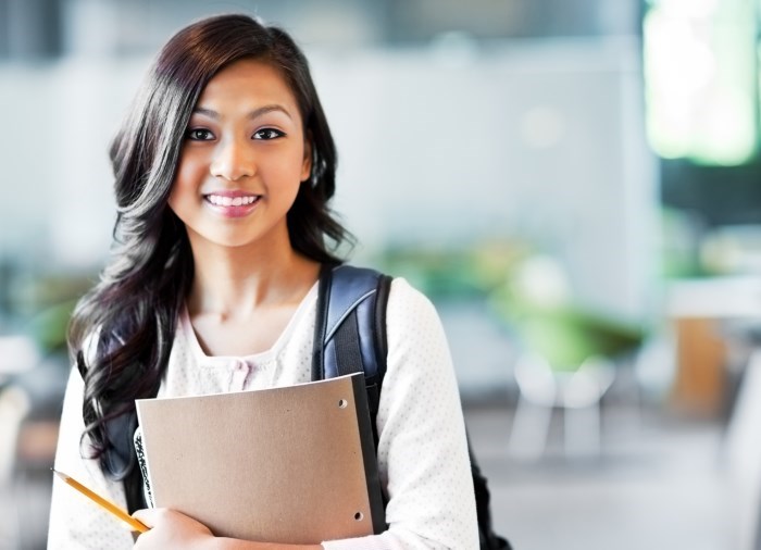 Young woman holding folder smiling