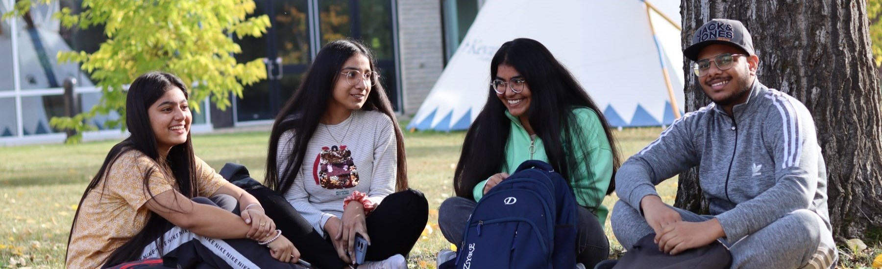 students smiling in park