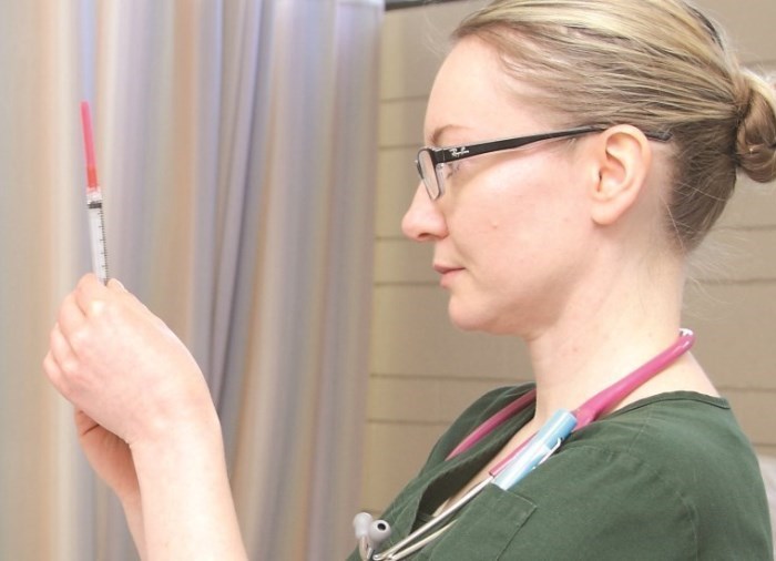 nurse holding syringe 