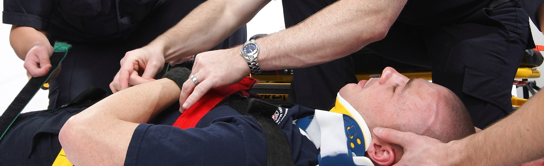 Men helping patient with ambulance