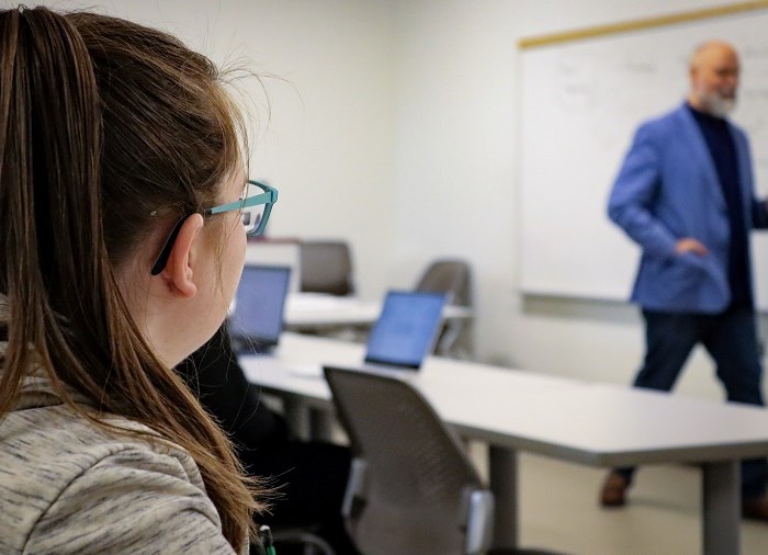 student in classroom listening to teacher