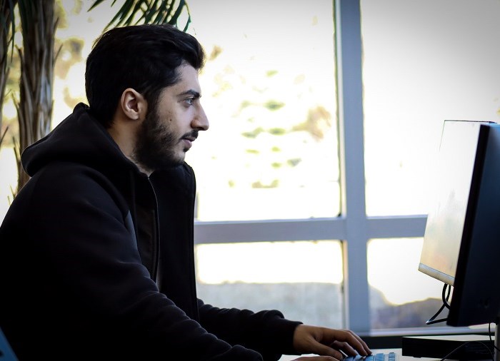 student at computer typing
