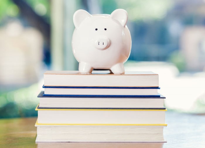 piggy bank on top of books