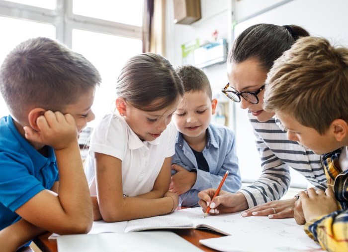 Teacher with students in a classroom