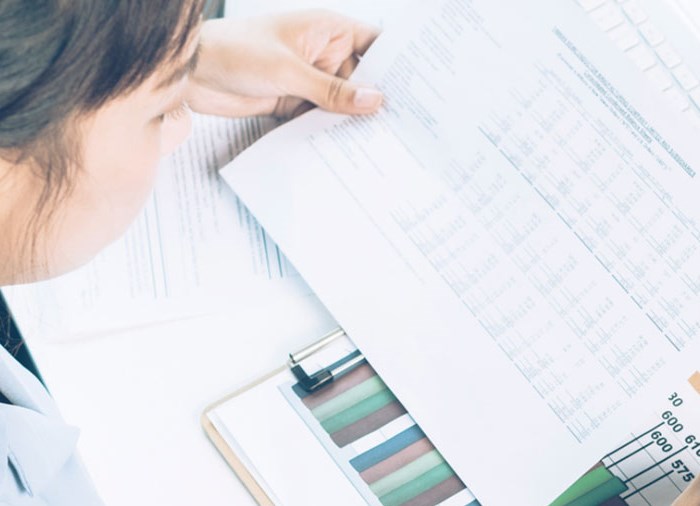 woman looking at paper