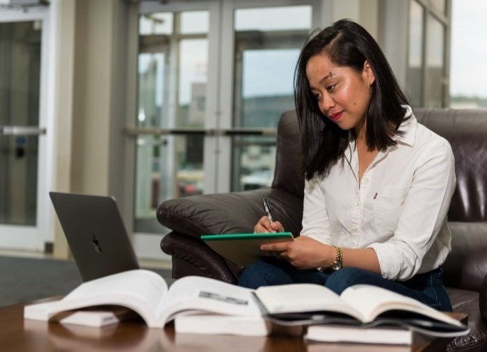 Student sitting in a chair studying