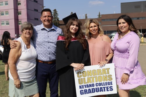 family standing outside of Keyano with their female graduate