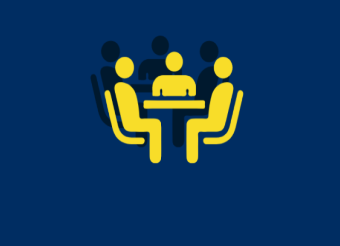Yellow figures of people sitting at a table on a blue background