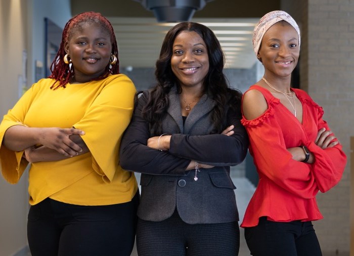 three ladies standing arms crossed