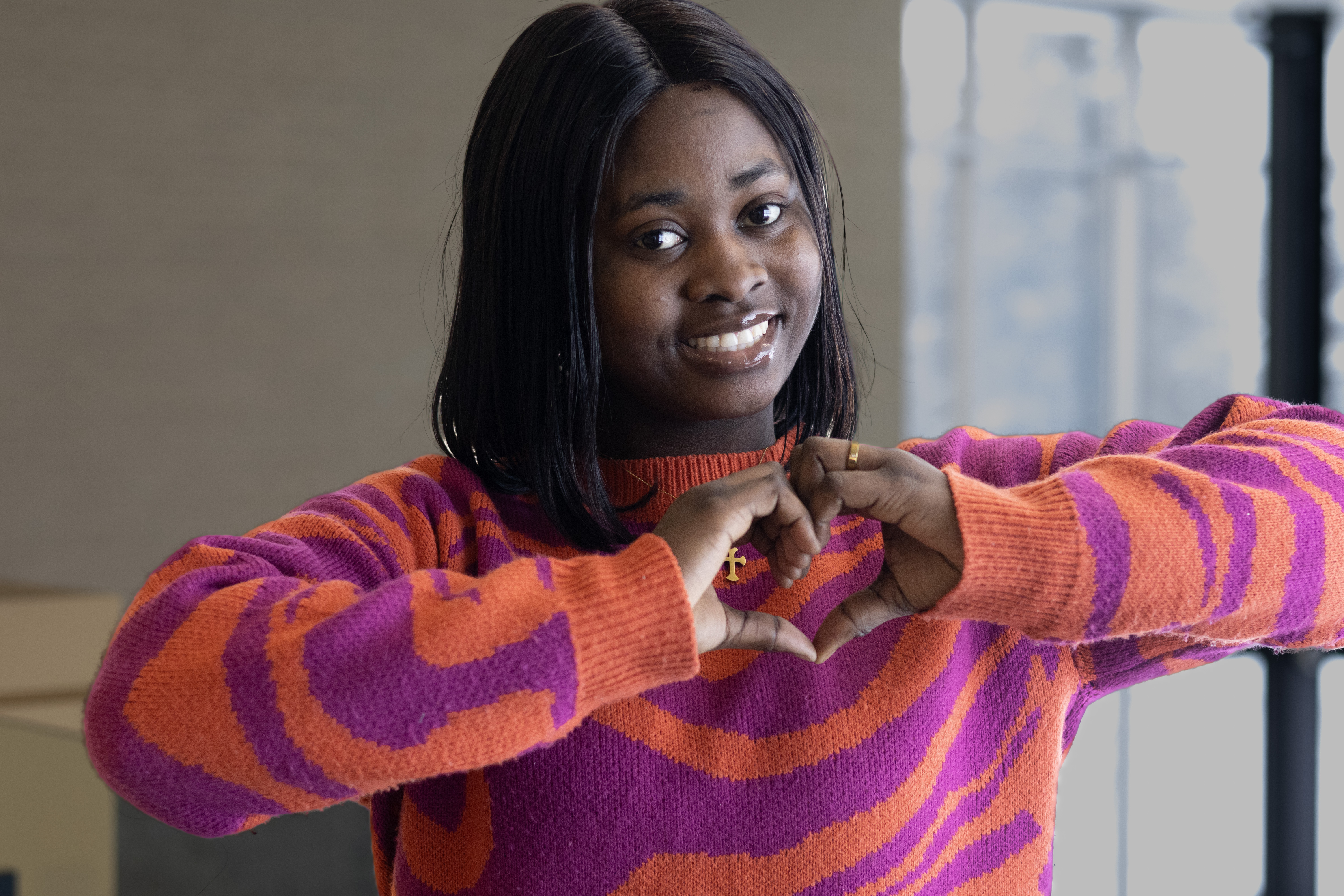 Cynthia Eyong making hands in heart shape 