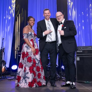 distinguished alumni with president and board chair