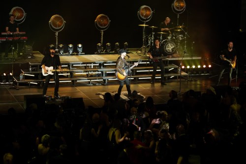 band on stage with crowd dancing