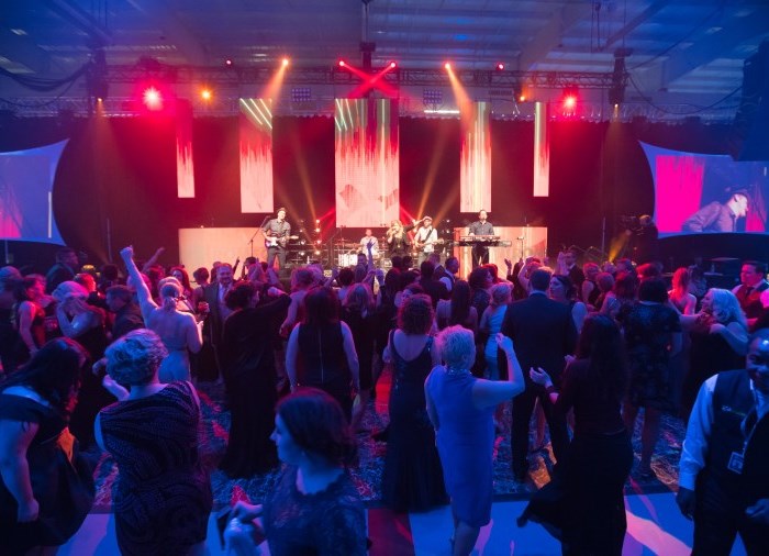 crowd at concert listening to band on stage