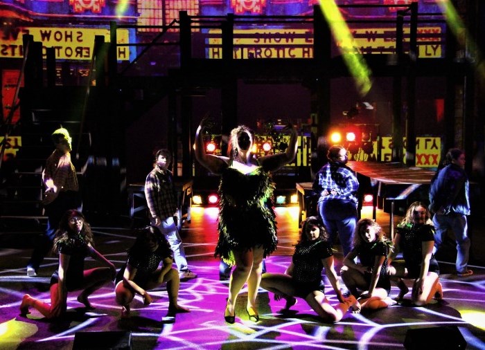 actors on stage in a musical