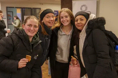 Four students smiling and posing for the camera