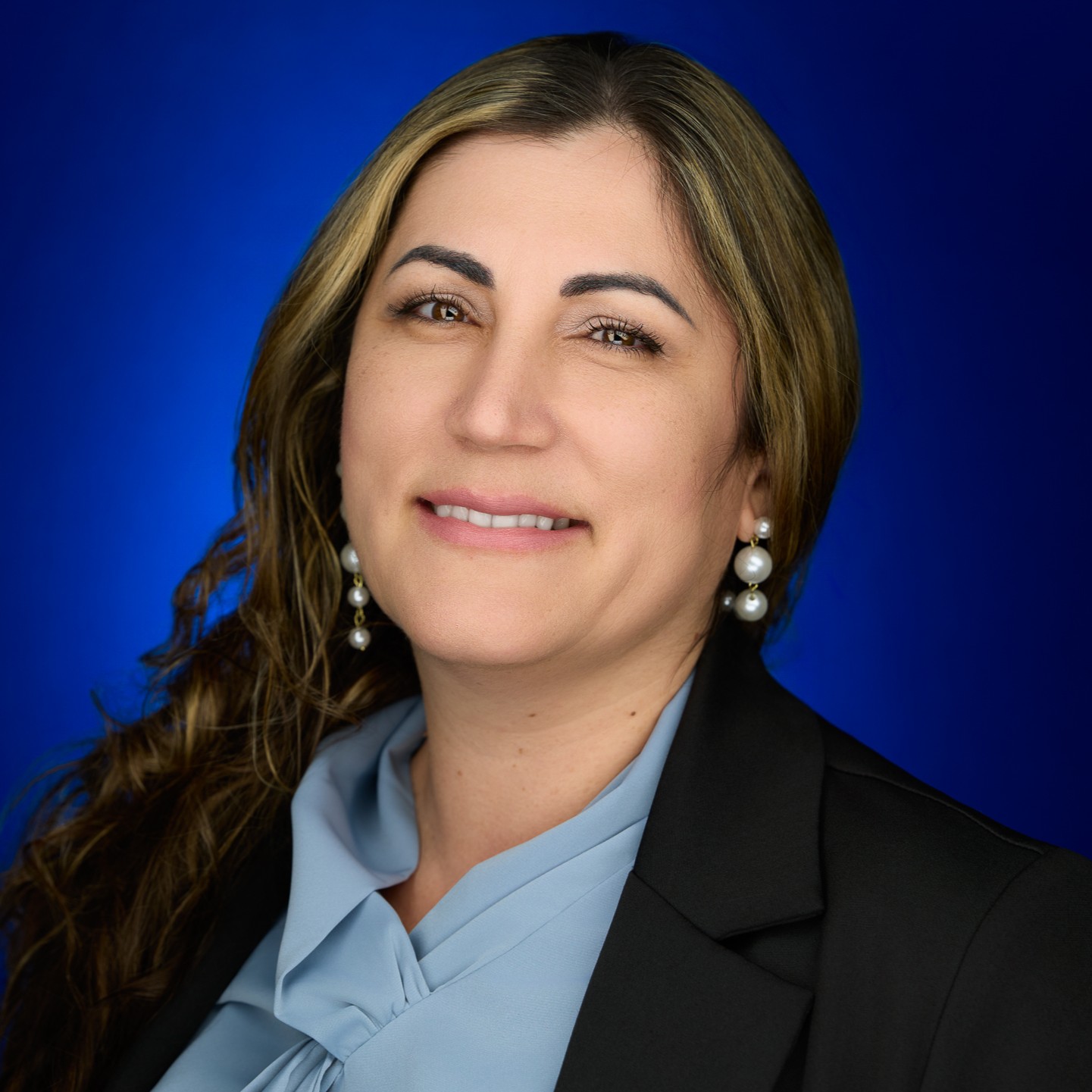 A headshot of Deni Ruiz