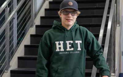 A headshot of Aidan Asher wearing a HET hoodie