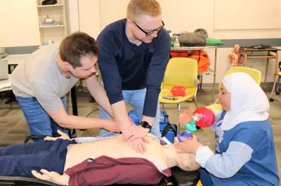 Students practicing CPR on the manequin