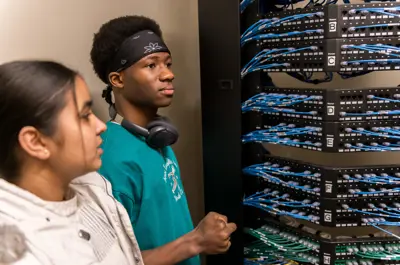 Two students looking at a Patch panel