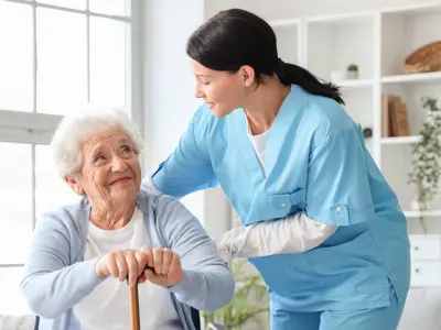 Senior woman with stick and nurse at home