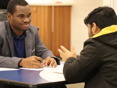 A student talking to a professor