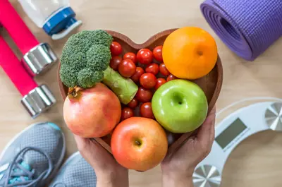 Broccoli, tomatoes, orange, apples and onion on a heart shaped tray
