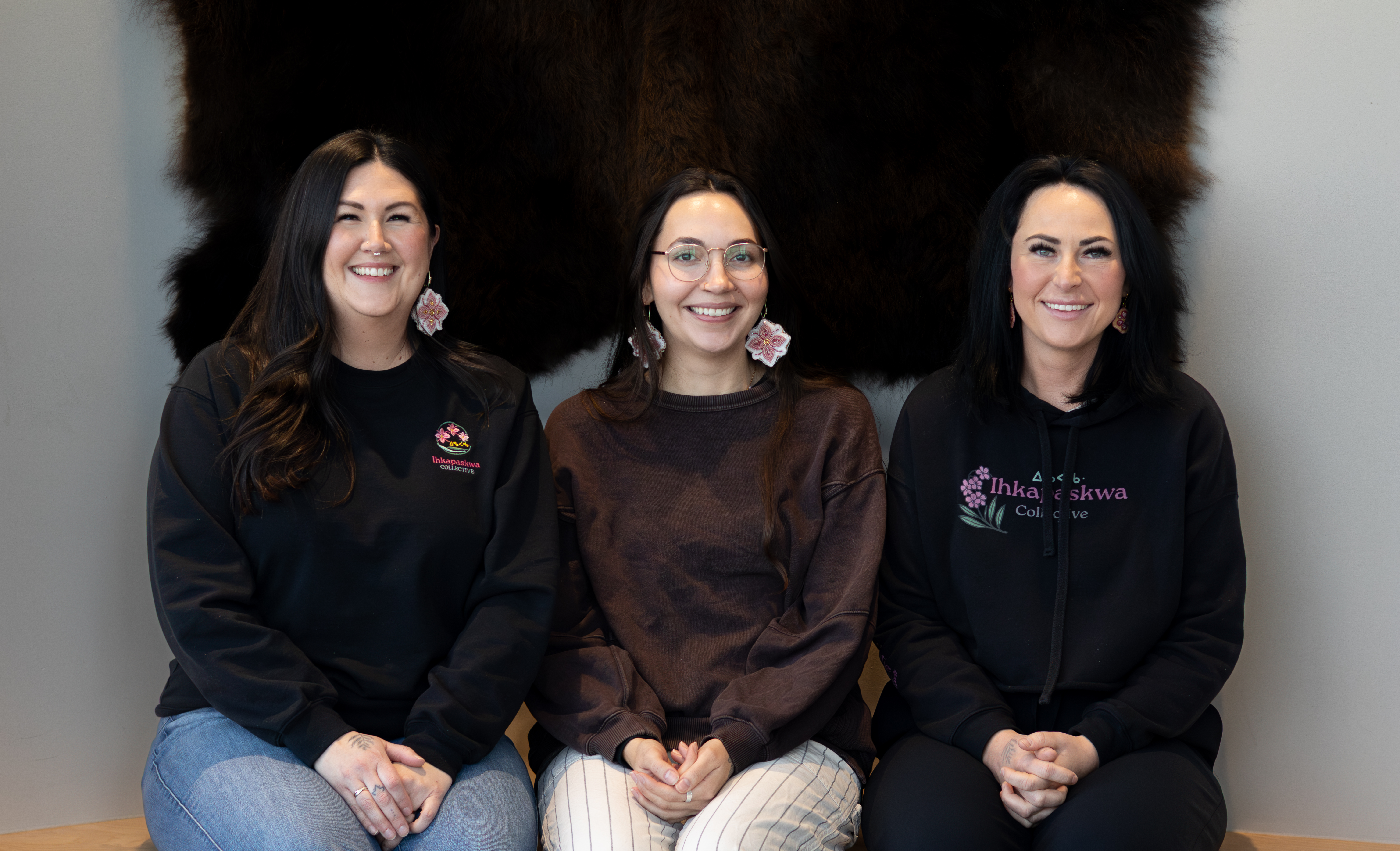 Three Indigenous women sitting side by side