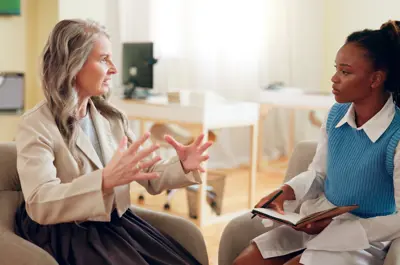 Woman, therapist or meeting with mentor for lesson, therapy session or psychiatry course at office. Female person, psychiatrist or coach talking to junior employee for mental health advice or talk