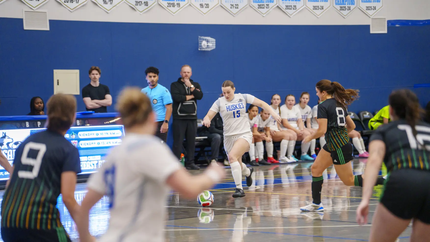 A student athlete chasing after a soccer ball