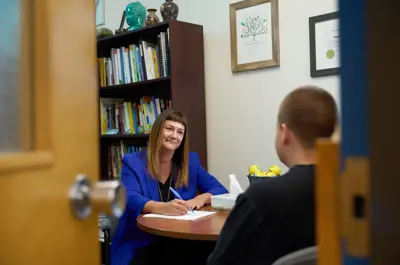 A woman providing counseling to a student